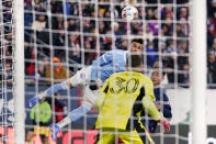 New York City midfielder Valentin Castellanos heads the ball towards New England Revolution goalkeeper Matt Turner (30) during the first half of an MLS playoff soccer match, Tuesday, Nov. 30, 2021, in Foxborough, Mass. (AP Photo/Charles Krupa)