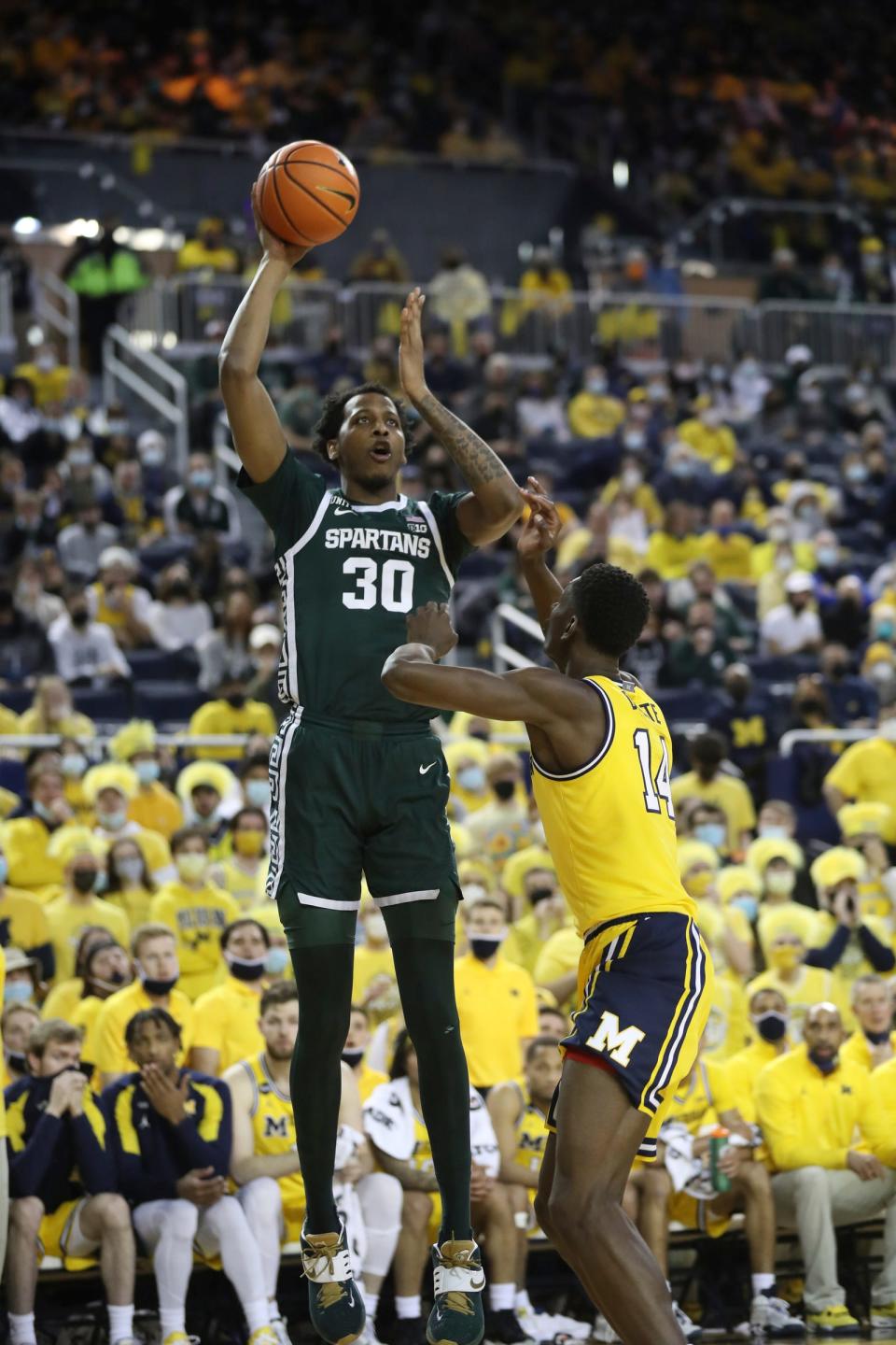 Michigan State Spartans forward Marcus Bingham Jr. (30) scores against Michigan Wolverines forward Moussa Diabate (14) during first half actionTuesday, Mar.1, 2022 at the Crisler Center.