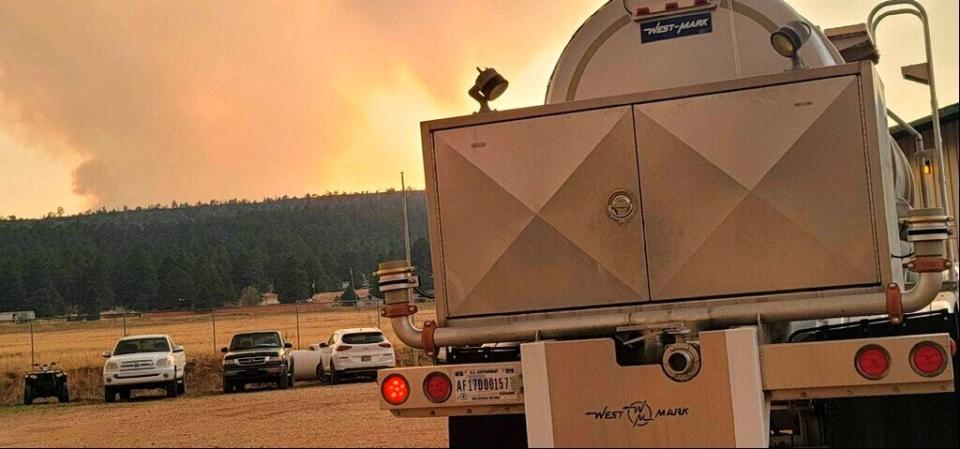 In this photo provided by the New Mexico National Guard, a New Mexico National Guard truck is ready to deliver potable water to communities in response to the Calf Canyon/Hermits Peak fire in northern New Mexico on Sunday, May 1, 2022. Thousands of firefighters battled destructive wildfires in the Southwest as more residents prepared to evacuate in northern New Mexico where strong winds and dangerously dry conditions have made the blazes hard to contain.