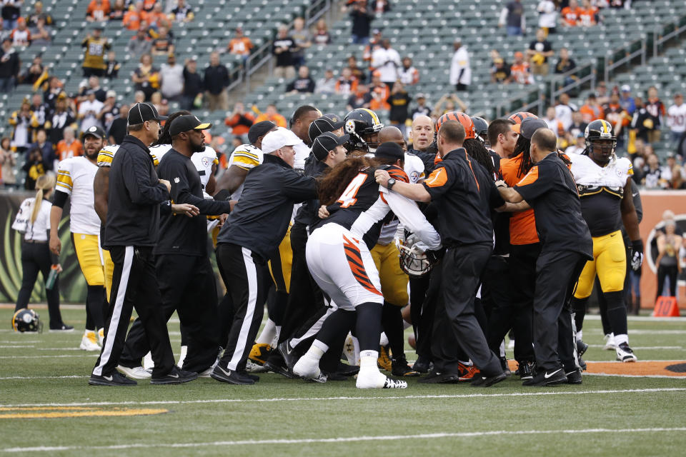 FILE - In this Dec. 13, 2015, file photo, a scrum breaks out on the field between the Cincinnati Bengals and the Pittsburgh Steelers players during practice before an NFL football game, in Cincinnati. The Bengals had two 15-yard penalties that helped the Steelers win a playoff game at Paul Brown Stadium in the 2015 season. They set a club record with 173 yards in penalties as Pittsburgh rallied to pull another one out last December. The theme for this week: Keep cool when the Steelers come to town again.(AP Photo/Frank Victores, File)