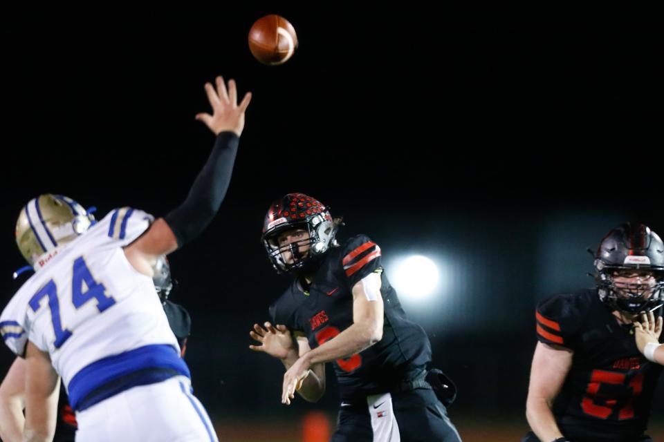 Rossville senior quarterback Torrey Horak (6) throws a pass to junior Kade Perine (22) against Riverton earlier this season. The Bulldogs won 56-14.