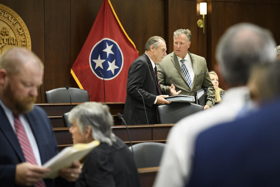 Sen. Mark Pody, R-Lebanon, left, talks with Rep. Scott Cepicky, R-Culleoka, right, before a state legislative committee meeting, Wednesday, July 21, 2021, in Nashville, Tenn. Being discussed amongst other things was the Department of Health vaccine administration following the firing of Dr. Michelle Fiscus, the state's top vaccine official, after state lawmakers complained about efforts to promote COVID-19 vaccination among teenagers. (AP Photo/John Amis)
