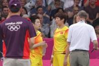 Badminton World Federation (BWF) referee Torsten Berg (R) alerts China's Yu Yang (2nd L) and Wang Xioli during their women's double badminton match against South Korea's Jung Kyun Eun and Kim Ha Na to play fairly at the London 2012 Olympic Games. Both pairs were later disqualified due to their conduct