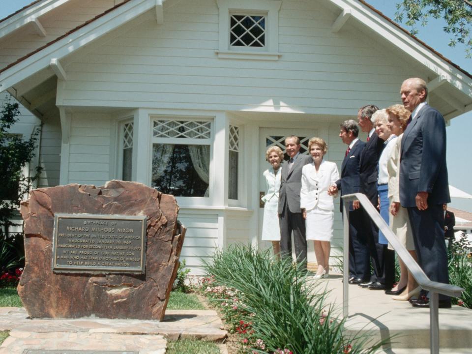 Richard and Pat Nixon, Ronald and Nancy Reagan, George and Barbara Bush, and Gerald and Betty Ford pose for a picture outside Richard Nixon's birthplace and childhood home.