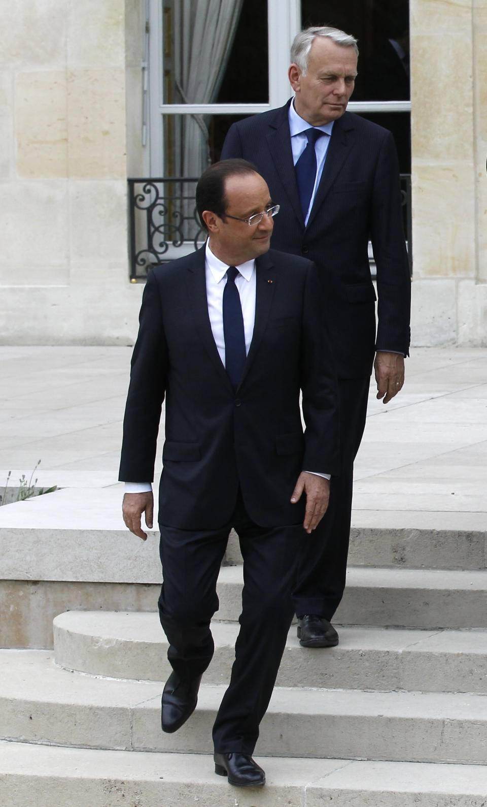 President Francois Hollande, followed by Prime Minister Jean-Luc Ayrault, arrives for the family picture after the weekly cabinet meeting, Thursday, May 17, 2012 at the Elysee Palace in Paris. (AP Photo/Michel Euler)
