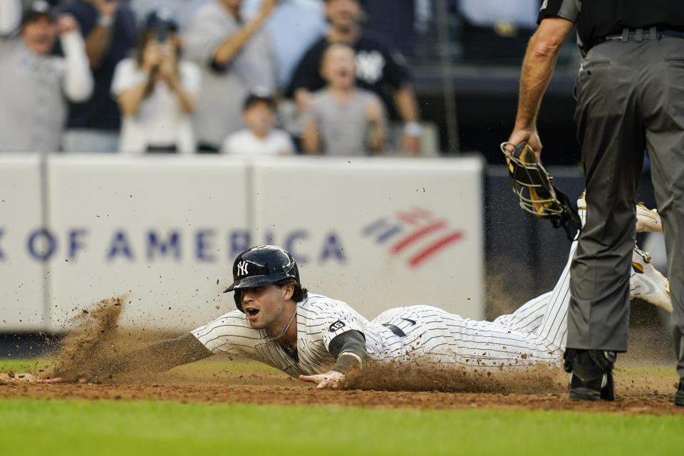 New York Yankees' Tyler Wade scores on a game winning RBI single by Aaron Judge during the ninth inning of a baseball game against the Tampa Bay Rays Sunday, Oct. 3, 2021, in New York. The Yankees won 1-0. (AP Photo/Frank Franklin II)