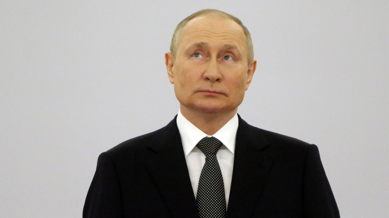 Vladimir Putin stands while attending the State Awarding Ceremony at the Grand Kremlin Palace in Moscow.