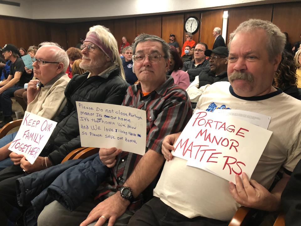 Portage Manor residents hold signs of support at the St. Joseph County Council meeting on Tuesday, March 14, 2023.