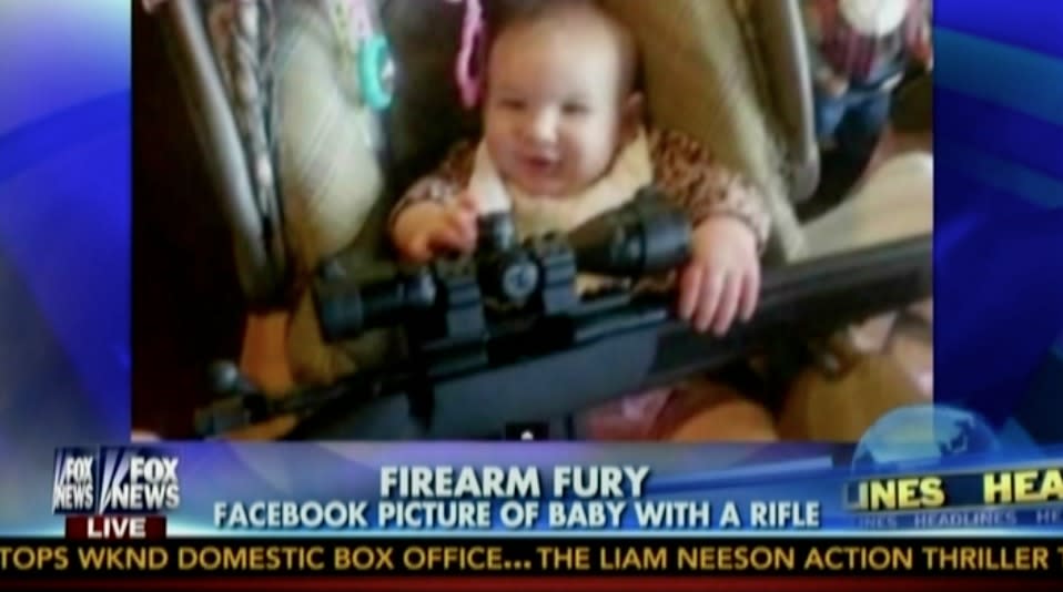 Baby holding gun