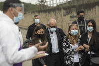 Relatives of COVID-19 victim Miryam Rodriguez listen to prayer outside Serafin Cemetery before her body is cremated in Bogota, Colombia, Friday, June 18, 2021. According to the regulations to contain the new coronavirus, relatives cannot enter the cemetery. (AP Photo/Ivan Valencia)