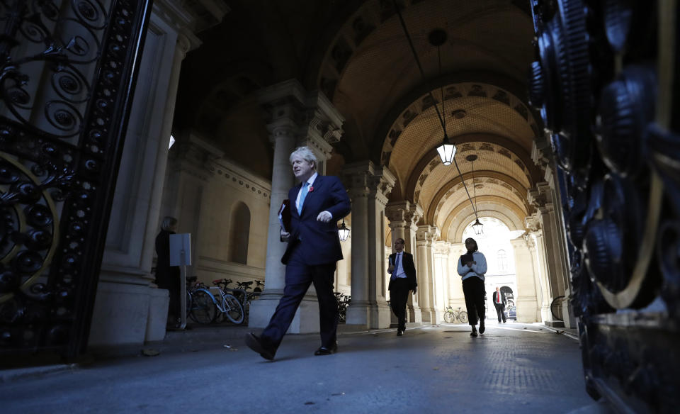Britain's Prime Minister Boris Johnson walks back towards10 Downing Street following a cabinet meeting in London, Tuesday, Nov. 3, 2020. The Cabinet meeting is held in the Foreign Office to allow for social distancing due to the ongoing Coronavirus pandemic, rather than the normal 10 Downing Street. (AP Photo/Frank Augstein)