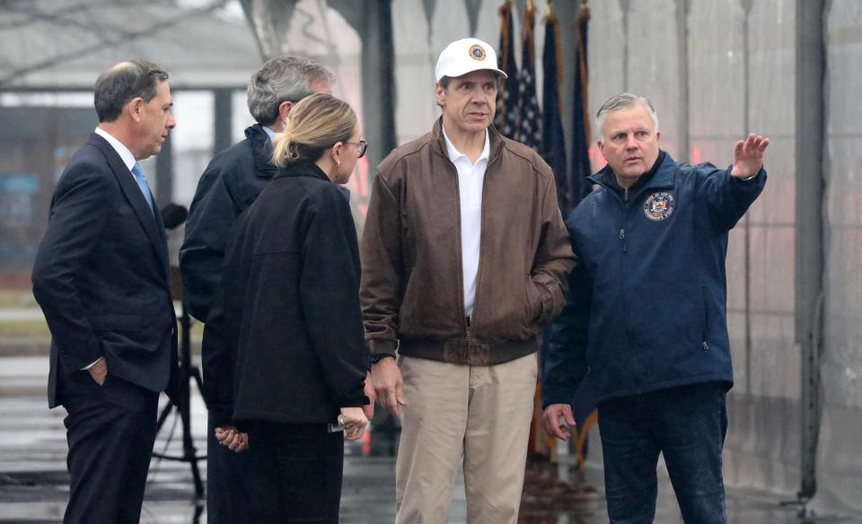 New York Governor Andrew Cuomo, in hat, gets a briefing from Michael Kopy, the NYS Director of Emergency Management, at Glen Island Park in New Rochelle, as New York State's first drive through COVID-19 mobile testing center opens, March 13, 2020.