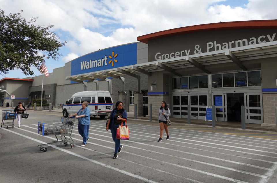 MIAMI, FLORIDA - JANUARY 24: Customers exit a Walmart store on January 24, 2023 in Miami, Florida. Walmart announced that it is raising its minimum wage for store employees in early March, store employees will make between $14 and $19 an hour. They currently earn between $12 and $18 an hour. (Photo by Joe Raedle/Getty Images)