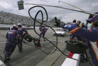 The pit crew scrambles to work as driver Denny Hamlin rolls in for a pitstop during a NASCAR Cup Series auto race, Sunday, Aug. 2, 2020, at the New Hampshire Motor Speedway in Loudon, N.H. (AP Photo/Charles Krupa)