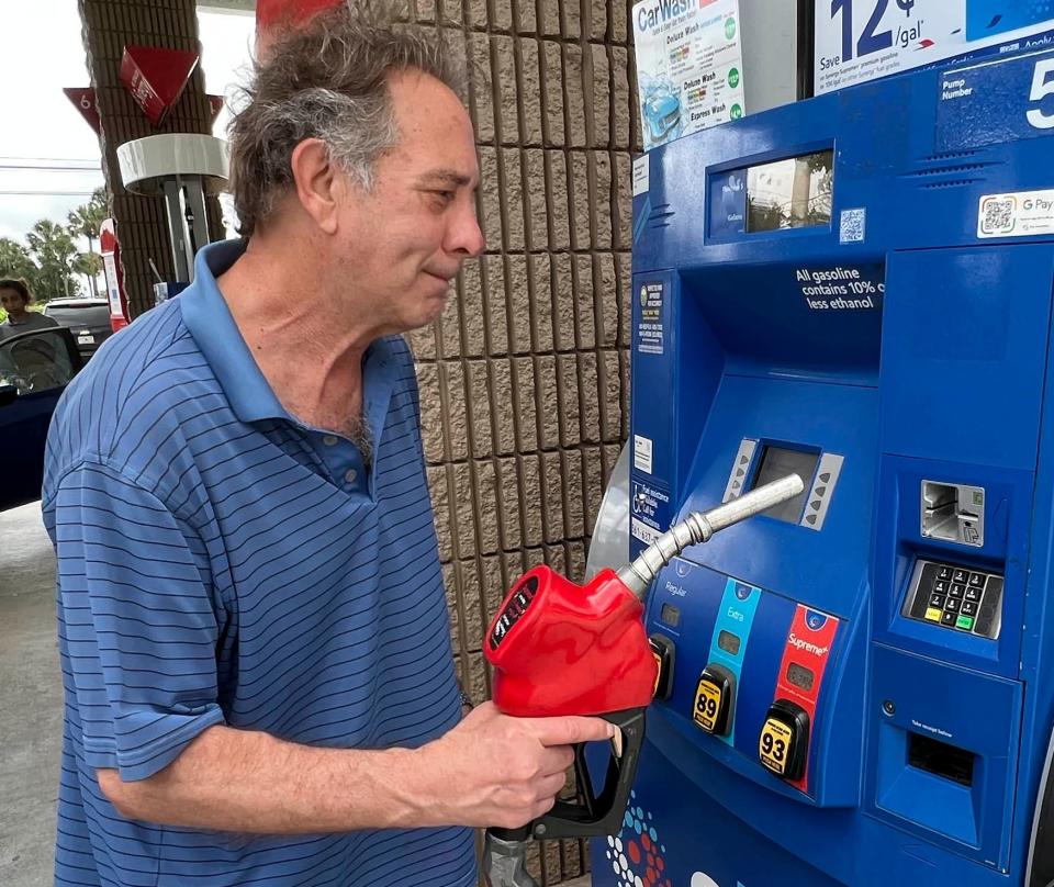 Howard Dobbs, 74, filling up his car Monday at a suburban Delray Beach Mobil gas station.