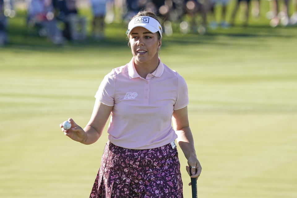Georgia Hall acknowledges the crowd on the 18th hole during the final round of the Drive On Championship golf tournament, Sunday, March 26, 2023, in Gold Canyon, Ariz. (AP Photo/Darryl Webb)