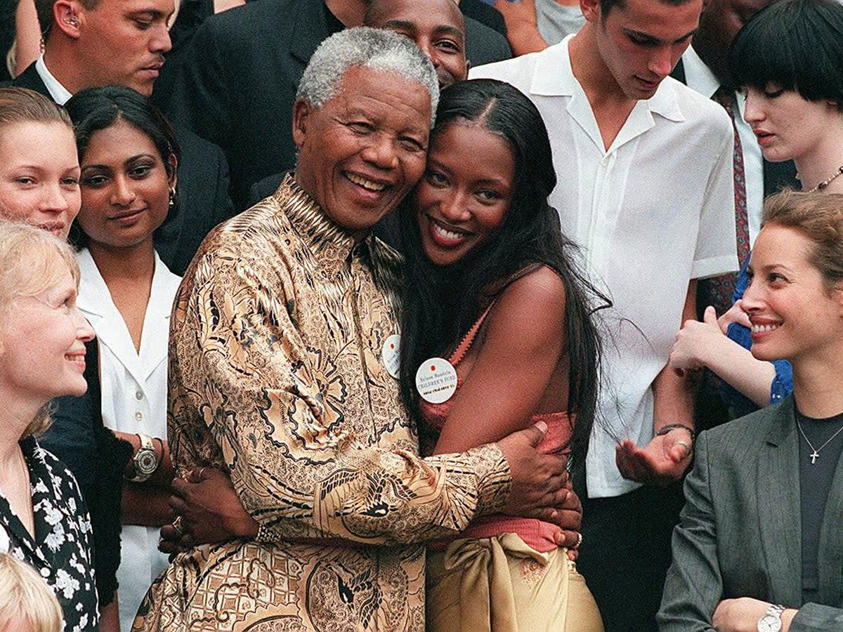 February 1998: Nelson Mandela (L) hugs British supermodel Naomi Campbell in front of American actress Mia Farrow, British model Kate Moss (second from left) and model Christy Turlington (AFP/Getty Images)