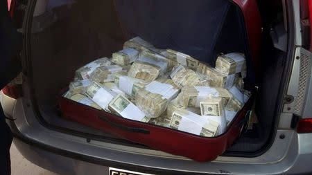 Packets of U.S. American dollars notes in plastic bags in the trunk of a car are seen in this handout picture in Buenos Aires, Argentina, June 14, 2016. REUTERS/Argentine Ministry of Security/Handout via Reuters
