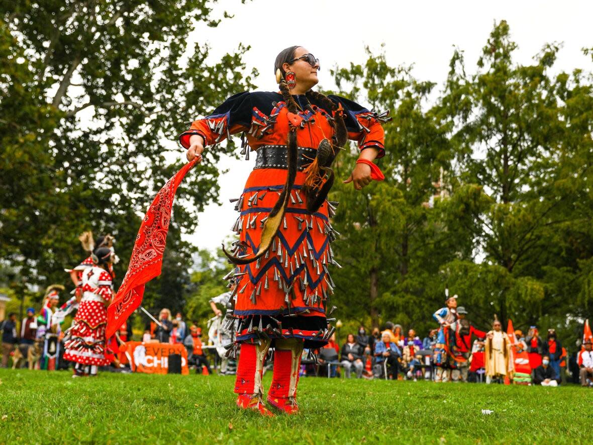 Jingle dress dancer, Danielle Migwans from the Ojibway Nation performs the side step dance during a healing ceremony held by Toronto Indigenous Harm Reduction, to commemorate National Day for Truth and Reconciliation at Allan Gardens in Toronto on Thursday, Sept. 30, 2021.  (Evan Buhler/Canadian Press - image credit)