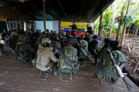 <p>Members of the 51st Front of the Revolutionary Armed Forces of Colombia (FARC) listen to a lecture on the peace process between the Colombian government and their force at a camp in Cordillera Oriental, Colombia, August 16, 2016. (John Vizcaino/Reuters) </p>