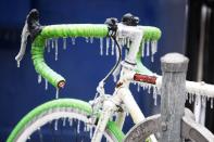 A bicycle is covered with ice after freezing rain in Toronto, Ontario December 22, 2013. Thousands of households are without power in the Greater Toronto area following an overnight ice storm. REUTERS/Hyungwon Kang (CANADA - Tags: ENVIRONMENT)