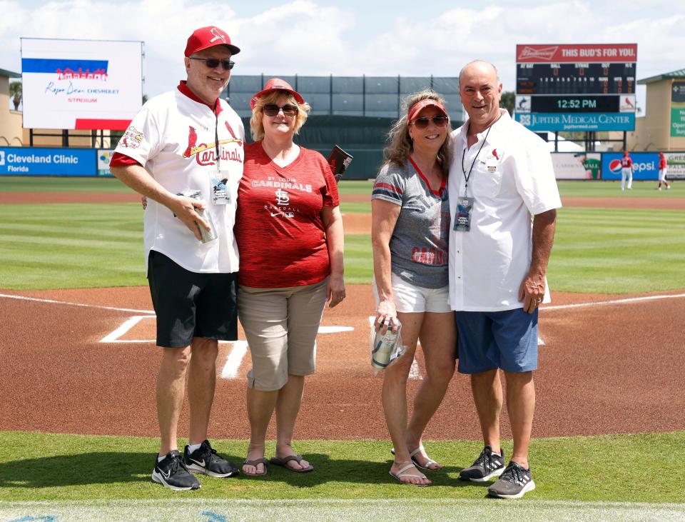 Mar 22, 2022; Jupiter, Florida, USA; Twenty five year season ticket holders (L-R) Mark and Cheryl Melville and  Tina and Ron Lantz were honored before the Florida Marlins against the St. Louis Cardinals game during spring training at Roger Dean Stadium. Mandatory Credit: Rhona Wise-USA TODAY Sports
