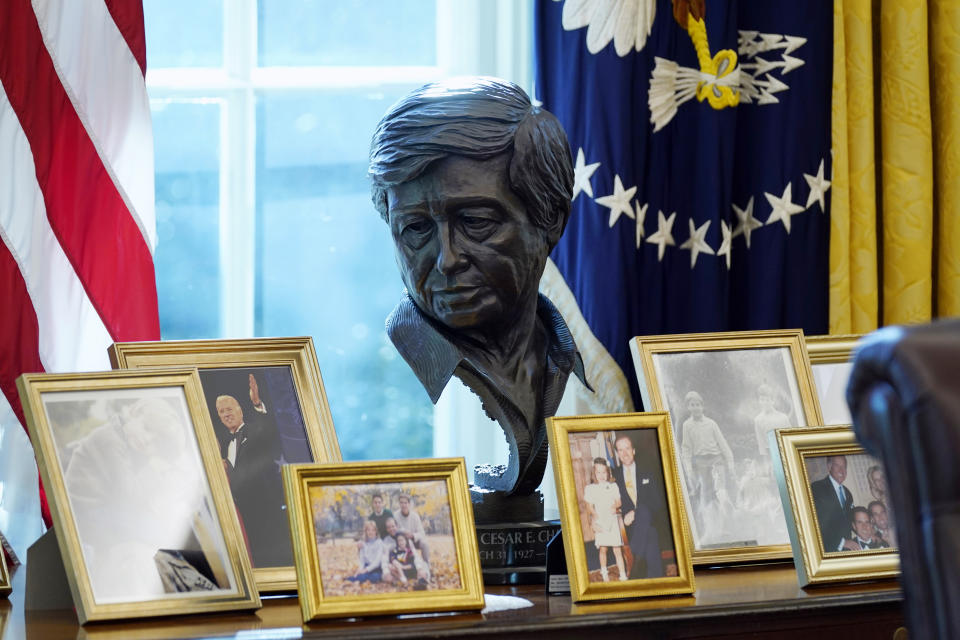 FILE - A sculpture of Latino American civil rights and labor leader Cesar Chavez is displayed in the Oval Office of the White House, Jan. 28, 2021, in Washington. The granddaughter of Cesar Chavez and a bronze bust of the late Latino labor activist have had prominent places in President Joe Biden’s White House. And now Julie Chavez Rodriguez is moving on from his White House staff to take another high-profile position at the helm of Biden's reelection campaign. (AP Photo/Evan Vucci, File)