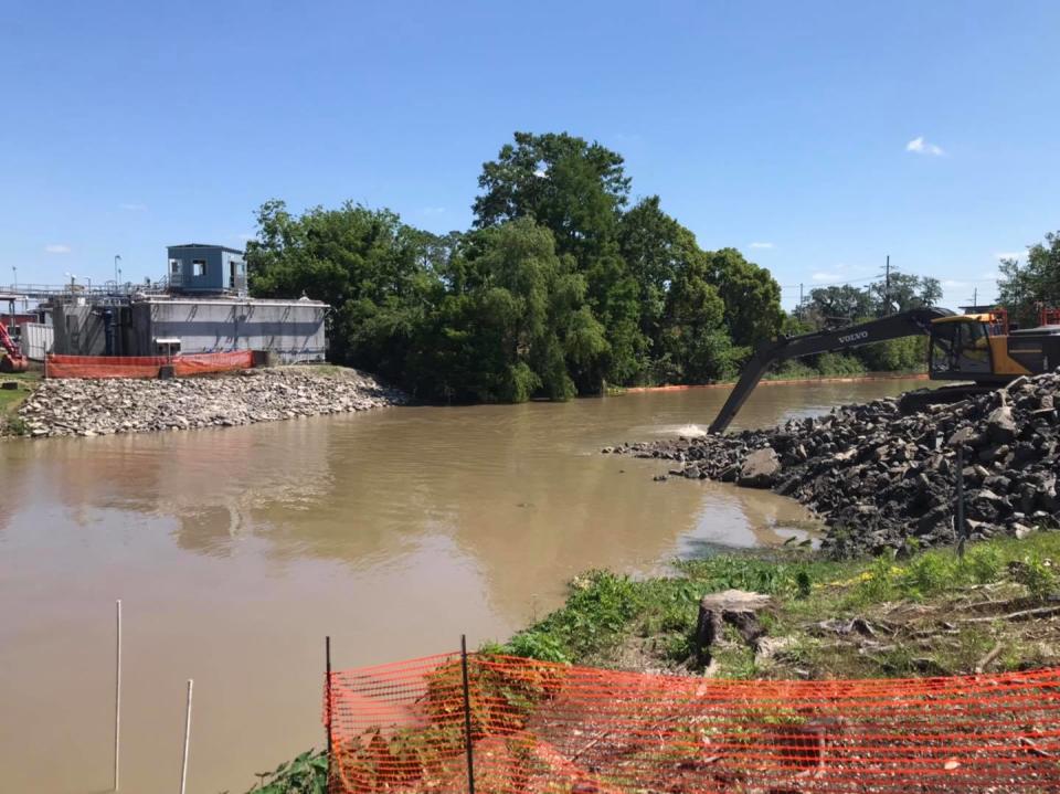 Workers remove a weir earlier this year in Bayou Lafourche in Thibodaux.