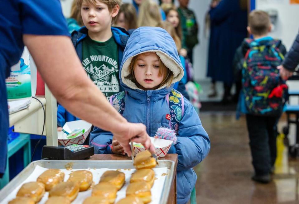 Students arriving early for breakfast on a January morning keep their winter coats on even after they get inside.