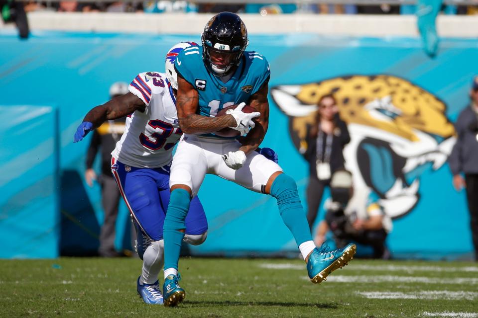 Jacksonville Jaguars wide receiver Marvin Jones Jr. (11) makes a reception in front of Buffalo Bills cornerback Siran Neal, left, during the first half of an NFL football game, Sunday, Nov. 7, 2021, in Jacksonville, Fla. (AP Photo/Stephen B. Morton)