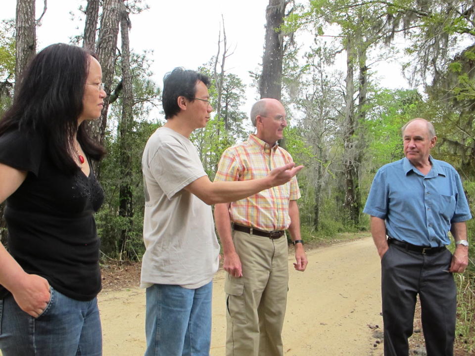 Clemson University researchers, from left, Bo Song, Alex Chow, William Conner and Tom Williams discuss sea level rise at Strawberry Swamp at Hobcaw Barony just outside Georgetown, S.C., on April 12, 2013. Clemson researchers have mapped the advance of salt water due to rising sea levels at the swamp during the past six decades. The study found a 300 percent increase in the salt marsh during the period. (AP Photo/Bruce Smith)