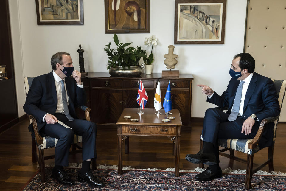 Cypriot Foreign Minister Nicos Christodoulides, right, and Britain's Secretary of State for Foreign Affairs, Dominic Raab, talk during their meeting at the foreign house in capital Nicosia, Cyprus, Thursday, Feb. 4, 2021. Raab is in Cyprus for one day of talks (Iakovos Hatzistavrou Pool via AP)