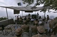 A senior army officer, center, briefs to Pakistani Foreign Minister Shah Mahmood Qureshi, Defense Minister Pervez Khattak and Moeed Yusuf, the National Security Advisor to the Prime Minister of Pakistan, during their visit to forward area post along a highly militarized frontier in the disputed region of Kashmir, in Chiri Kot sector, Pakistan, Monday, Aug. 3, 2020. The region's top Pakistani military commander briefed ministers about Indian cease-fire violations in Kashmir, which is split between Pakistan and India and claimed by both in its entirety. (AP Photo/Anjum Naveed)