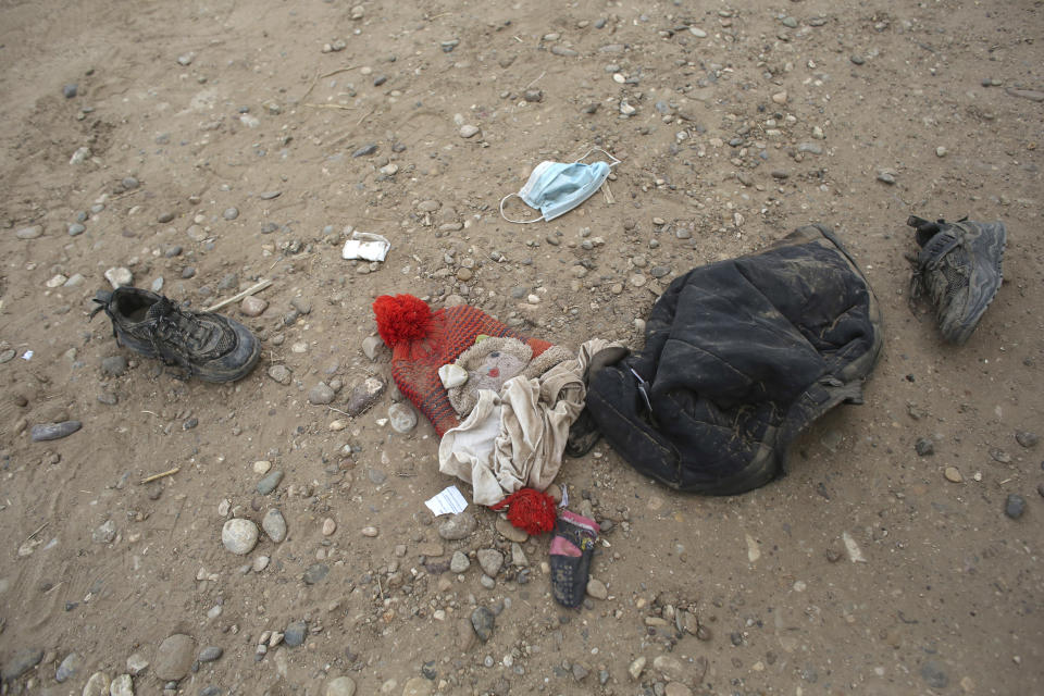 Personal items lie on the ground that were left behind by migrants who had crossed the Rio Grande river into the United States and taken into custody of the Border Patrol in Eagle Pass, Texas, Friday, May 20, 2022. As U.S. officials anxiously waited, many of the migrants crossing the border from Mexico on Friday were oblivious to a pending momentous court ruling on whether to maintain pandemic-related powers that deny a chance to seek asylum on grounds of preventing the spread of COVID-19. (AP Photo/Dario Lopez-Mills)