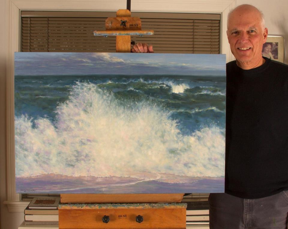 Artist William Gotha with his oil painting "Wave Action II" that shows Nauset Beach in Orleans.