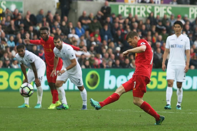 Liverpool's midfielder James Milner (2ndR) scores from the penalty spot on October 1, 2016