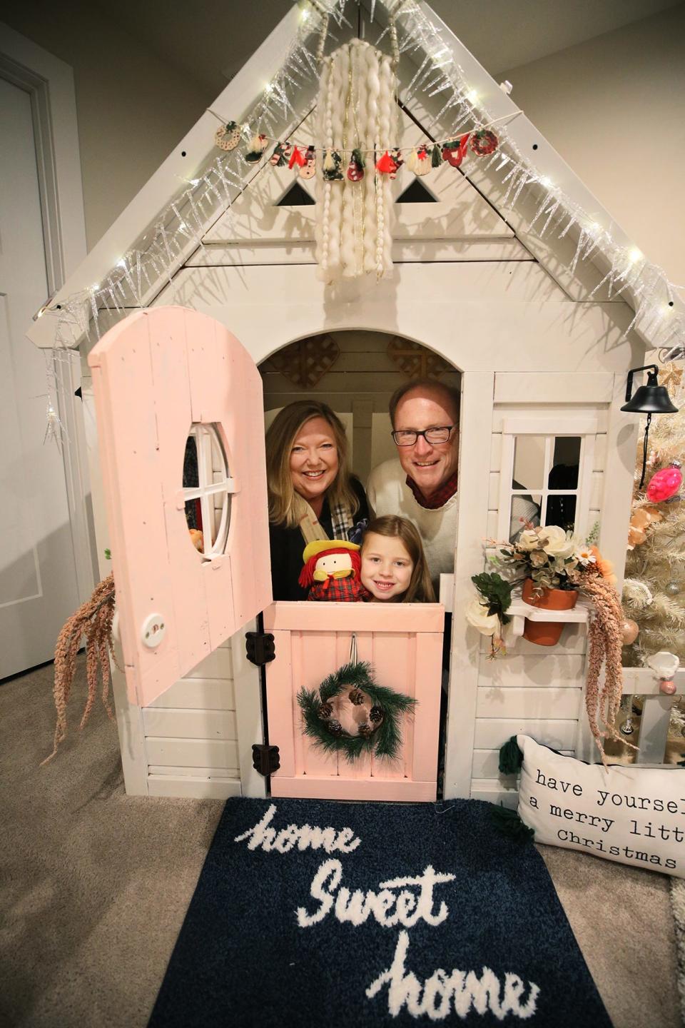 Surrogate grandparents Lara and Rich Wilson join LJ Horvath, 5, inside her playhouse in the basement of the Horvaths' Lafayette Township home.