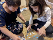 In this photo provided by Christina Neu, Christina Neu works on a puzzle with her six-year-old daughter Charissa Wednesday, June 9, 2021, in Wichita, Kan. Neu didn't enroll Charissa in kindergarten last fall even though she would have been one of the older kids in her class because of concerns about the pandemic. (Christina Neu via AP)