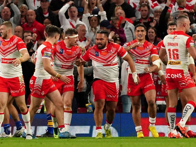 Konrad Hurrell, centre, celebrates his try