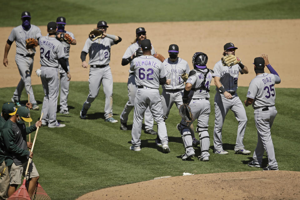 Colorado Rockies celebrate after the 5-1 defeat of the Oakland Athletics at the end of a baseball game Wednesday, July 29, 2020, in Oakland, Calif. (AP Photo/Ben Margot)