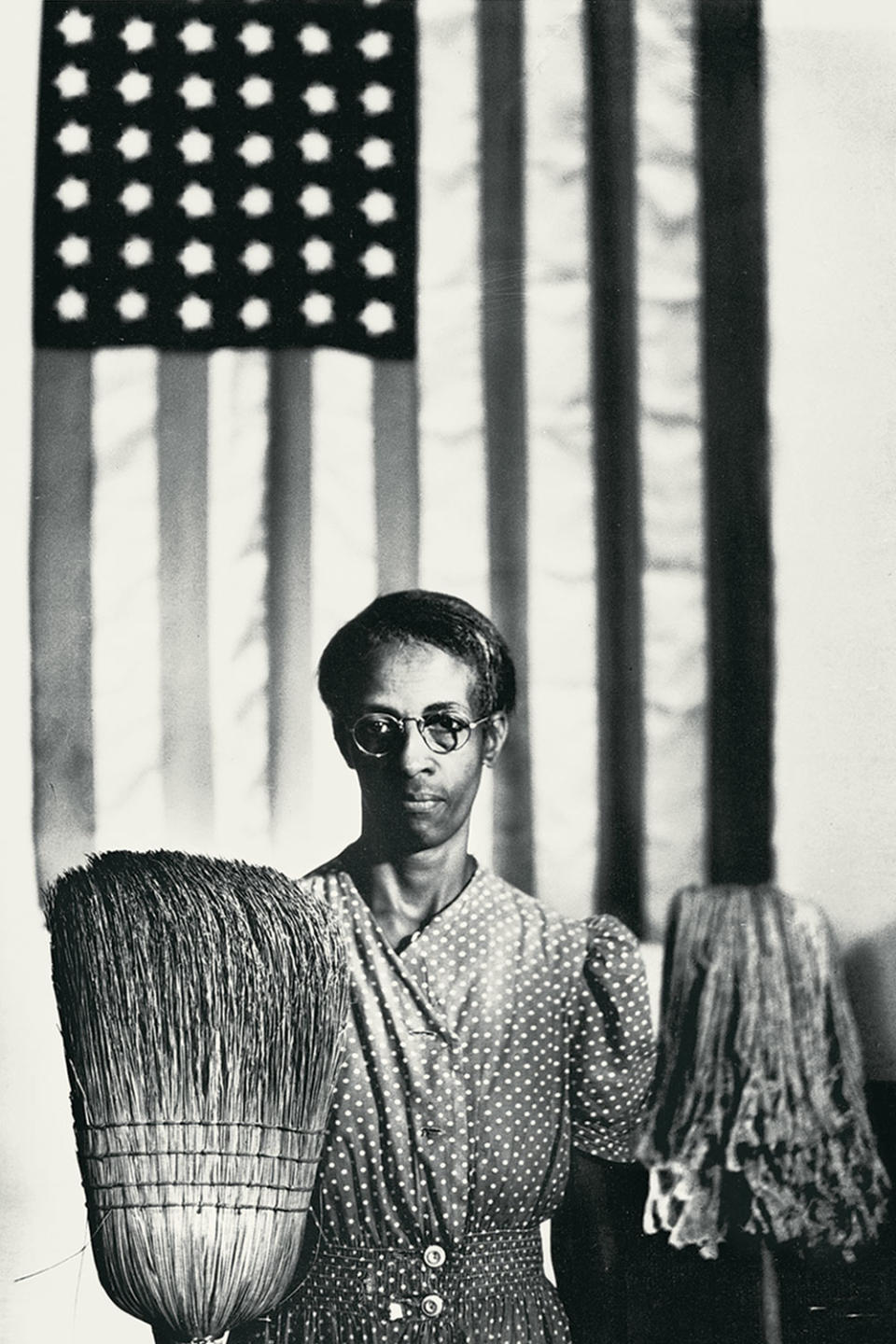 <p>Ella Watson standing with a broom and mop in front of the American flag was photographer Gordon Parks' reinterpretation of Grant Wood's "American Gothic" painting, as part of a project for the Farm Security Administration in 1942. (<a href="https://www.loc.gov/collections/fsa-owi-black-and-white-negatives/articles-and-essays/documenting-america/ella-watson-united-states-government-charwoman/" rel="nofollow noopener" target="_blank" data-ylk="slk:Learn more about his photographs of Watson here;elm:context_link;itc:0;sec:content-canvas" class="link ">Learn more about his photographs of Watson here</a>.)</p>