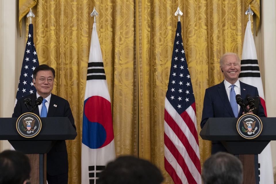 South Korean President Moon Jae-in, left, smiles with President Joe Biden during a joint news conference in the East Room of the White House, Friday, May 21, 2021, in Washington. (AP Photo/Alex Brandon)