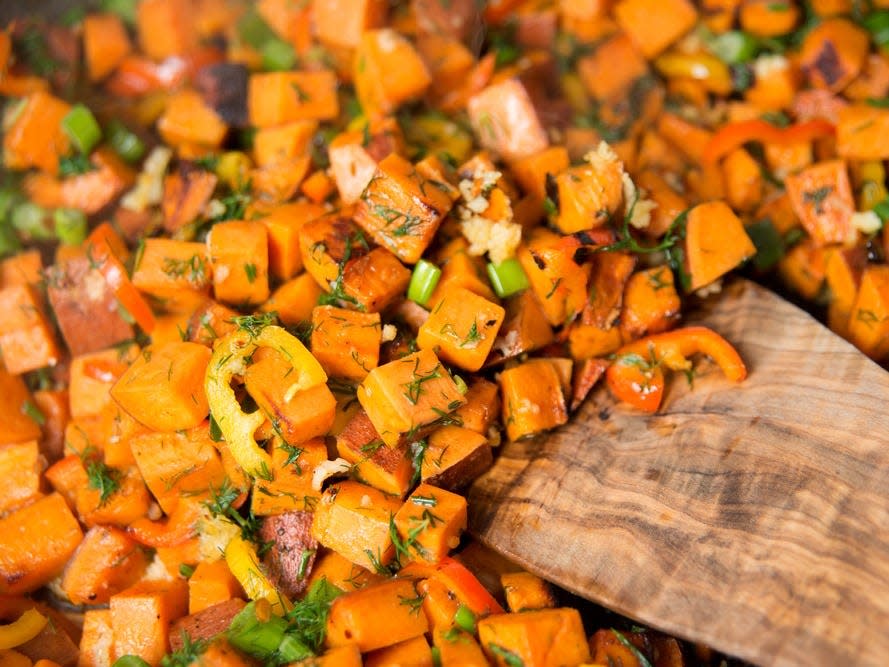 chopped sweet potato and wooden spoon