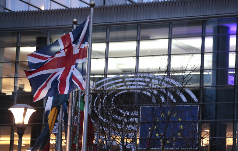 The Union flag flaps in the wind with flags of other EU countries outside the European Parliament in Brussels, Friday, Jan. 31, 2020. The U.K. is due to leave the EU on Friday the first nation in the bloc to do so. (AP Photo/Virginia Mayo)