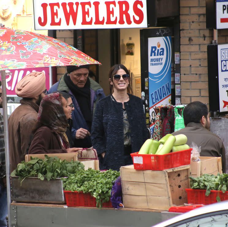 Sandra Bullock is all smiles as she films in an Indian shopping district on the set of 'Ocean's 8' in Queens, NY. Sandra was laughing with the extras during a break and even made some faces as she got an actual real phone call on her cell phone that was not a part of the scene as the director had to cut for a moment. The actress was also using an older Iphone in the scene even though the film will not be released until the Summer of 2018. Pictured: Sandra Bullock Ref: SPL1410052 131216 Picture by: Brian Prahl / Splash News Splash News and Pictures Los Angeles:310-821-2666 New York:212-619-2666 London:870-934-2666 photodesk@splashnews.com 