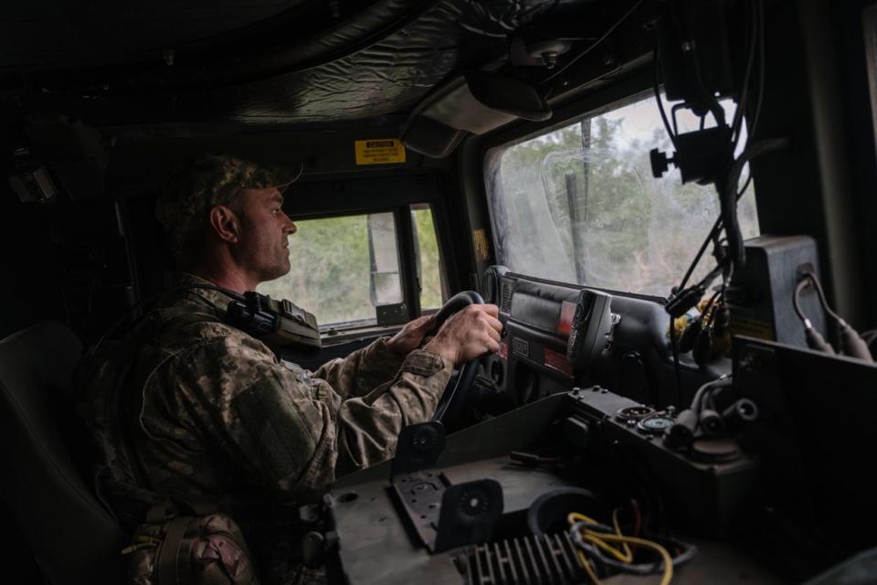 A Ukrainian soldier driving a U.S.-built HMMWV armored vehicle into Chasiv Yar, Donetsk Oblast, on April 26, 2024. (Francis Farrell/The Kyiv Independent)
