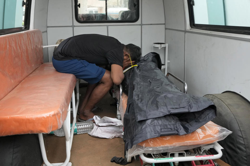 A man mourns by the body of his 37-year-old sister Ruby, victim of a stampede, outside Hathras district hospital, Uttar Pradesh, India, Wednesday, July 3, 2024. Thousands of people at a religious gathering rushed to leave a makeshift tent, setting off a stampede Tuesday that killed more than hundred people and injured scores. (AP Photo/Rajesh Kumar Singh)