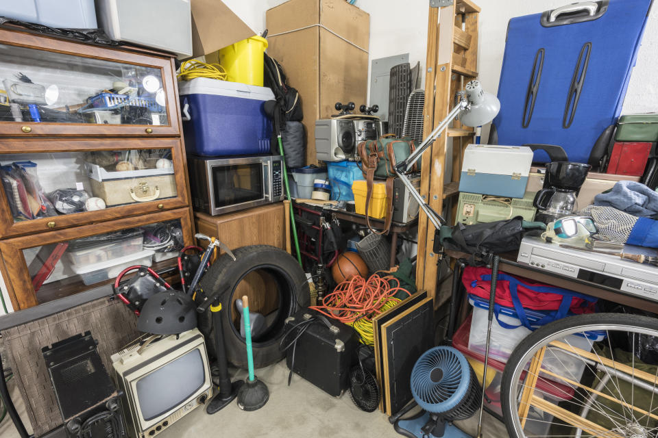 Cluttered corner full of household storage items and vintage electronics.