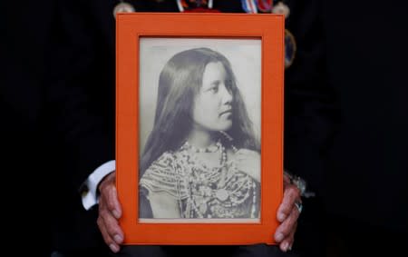 Charles Norman Shay, 94, a Penobscot Native American Indian WWII veteran, poses holding a picture of his mother Florence as he attends an interview with Reuters in Bretteville l'Orgueilleuse