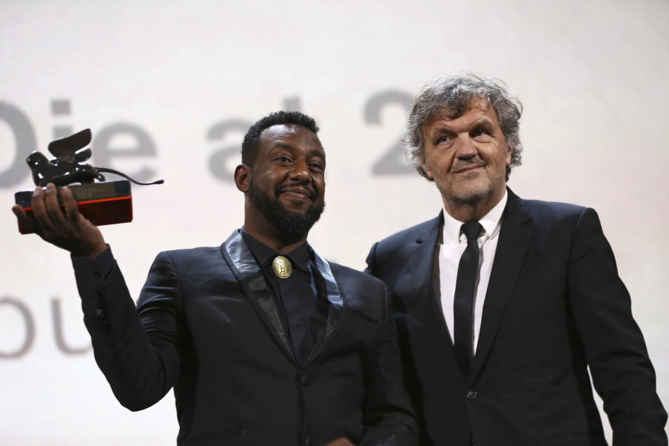 Director Amjad Abu Alala, left, holds the Luigi De Laurentiis Venice Award for a Debut Film for the film 'You Will Die At 20', presented by jury member Emir Kustirica at the closing ceremony of the 76th edition of the Venice Film Festival, Venice, Italy, Saturday, Sept. 7, 2019. (Photo by Joel C Ryan/Invision/AP)